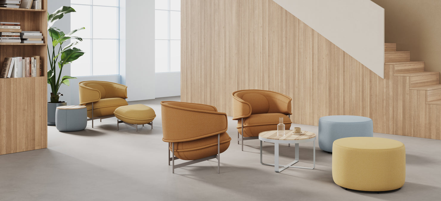 Flote Lounge Chairs paired with Flote Ottomans and Breck Tables, arranged in a modern lounge space with a minimalist wood backdrop and natural light.