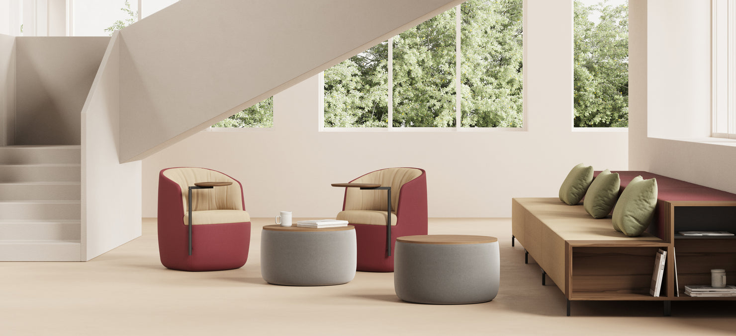 Gimbal Jr. Lounge Chairs paired with Gimbal Jr. Pivot Tables and a 37.5-inch Breck Table, set in a bright space with large windows, stairs, and natural light.